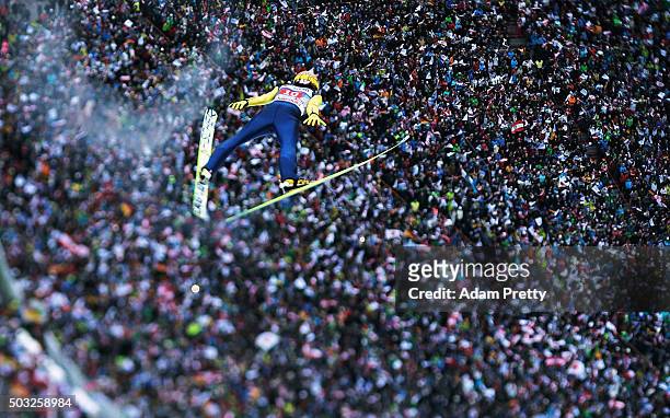 Noriaki Kasai soars through the air and over the grandstand during his final competition jump on day 2 of the Innsbruck 64th Four Hills Tournament on...