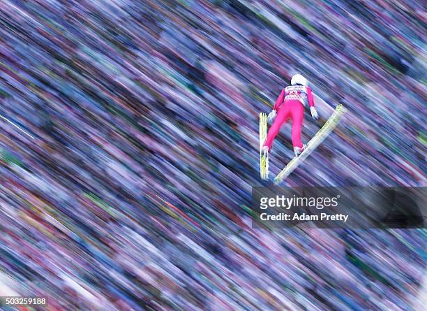 Simon Ammann of Switzerland soars through the air and over the grandstand during his final competition jump on day 2 of the Innsbruck 64th Four Hills...
