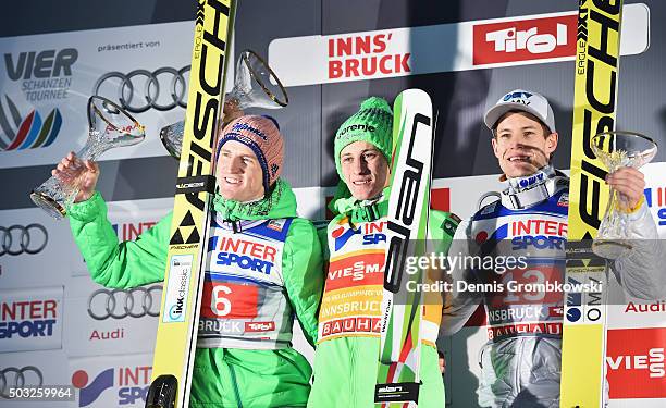 Severin Freund of Germany, Peter Prevc of Slovenia and Kenneth Gangnes of Norway celebrate on the podium after Day 2 of the Innsbruck 64th Four Hills...