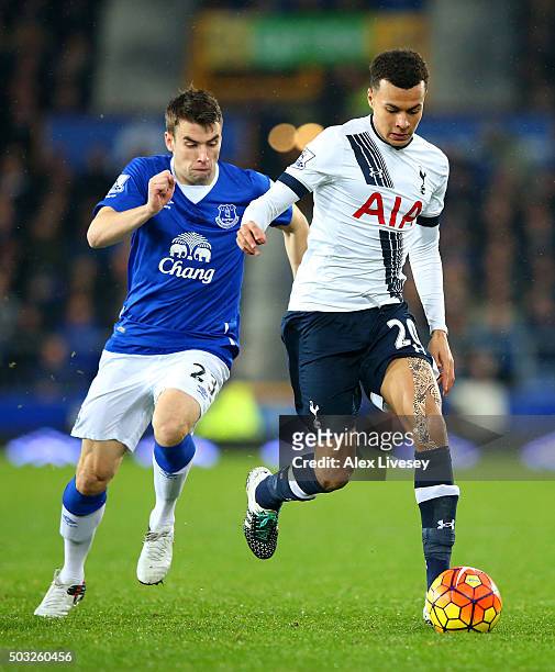 Dele Alli of Tottenham Hotspur runs with the ball under pressure from Seamus Coleman of Everton during the Barclays Premier League match between...