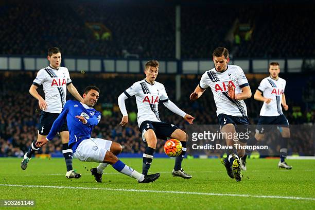 Aaron Lennon of Everton crosses the ball under pressure from the Tottenham defence during the Barclays Premier League match between Everton and...