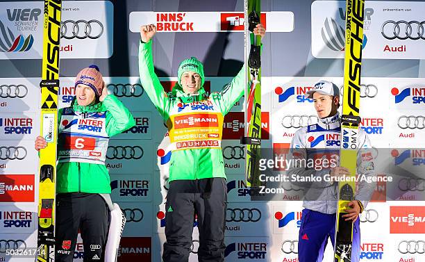 Severin Freund of Germany takes 2nd place, Peter Prevc of Slovenia takes 1st place, Kenneth Gangnes of Norway takes 3rd place during the FIS Nordic...