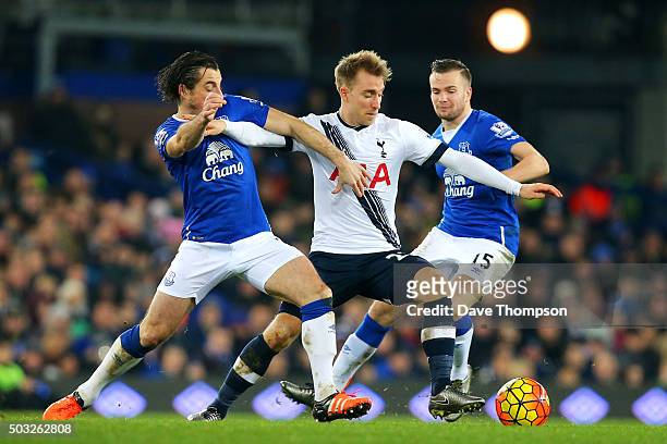 Christian Eriksen of Tottenham Hotspur battles for the ball with Leighton Baines and Tom Cleverley of Everton during the Barclays Premier League...