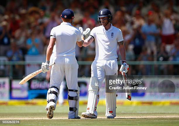Jonny Bairstow of England and Ben Stokes of England support each other in their partnership during day two of the 2nd Test at Newlands Stadium on...