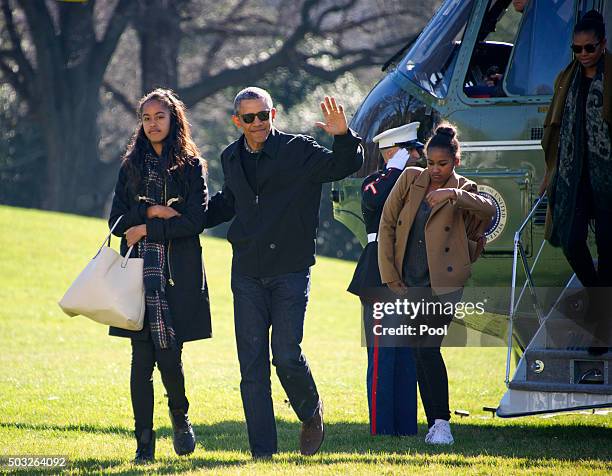 President Barack Obama and his family Malia, Sasha, and first lady Michelle Obama return to the South Lawn of the White HouseJanuary 3, 2016 in...