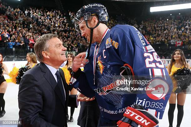 President Rene Fasel welcomes captain Eric Chouinard of Grenoble during the final of French Cup between Dragons de Rouen and Bruleurs de Loups de...
