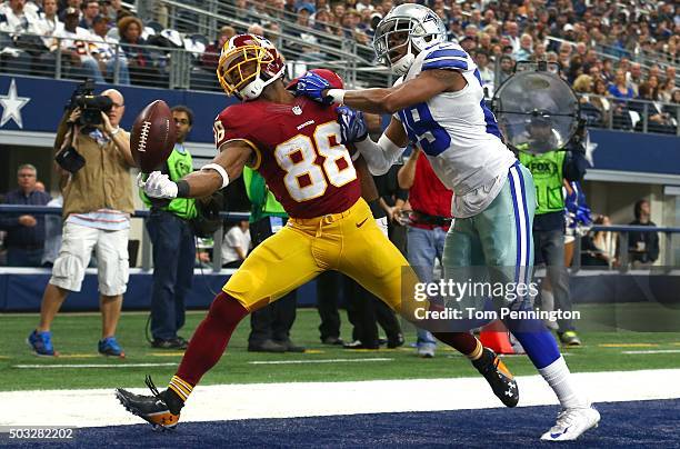 Pierre Garcon of the Washington Redskins attempts to make a touchdown catch against Deji Olatoye of the Dallas Cowboys during the first half at AT&T...