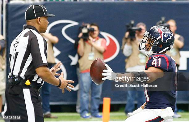 Jonathan Grimes of the Houston Texans hands the ball to an official after his three yard touchdown run against the Jacksonville Jaguars in the second...