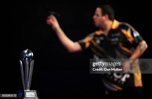 The Sid Waddell Trophy is displayed as Adrian Lewis of England throws against Gary Anderson of Scotland in the final match during Day Fifteen of the...