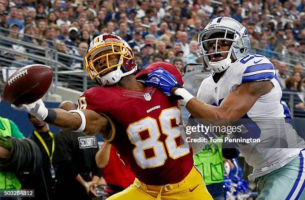 Pierre Garcon of the Washington Redskins attempts to make a catch against Deji Olatoye of the Dallas Cowboys during the first half at AT&T Stadium on...