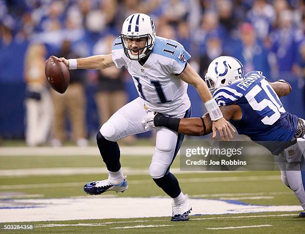 Alex Tanney of the Tennessee Titans is sacked by Jerrell Freeman of the Indianapolis Colts at Lucas Oil Stadium on January 3, 2016 in Indianapolis,...