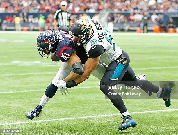 Jonathan Grimes of the Houston Texans is tackled by Paul Posluszny of the Jacksonville Jaguars in the second quarter on January 3, 2016 at NRG...