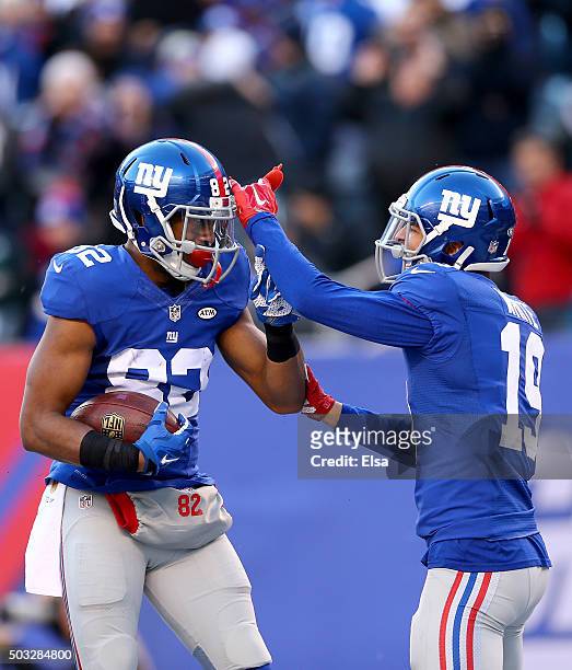 Rueben Randle of the New York Giants celebrates with his teammate Myles White after scoring a 45 yard touchdown in the third quarter to take the lead...