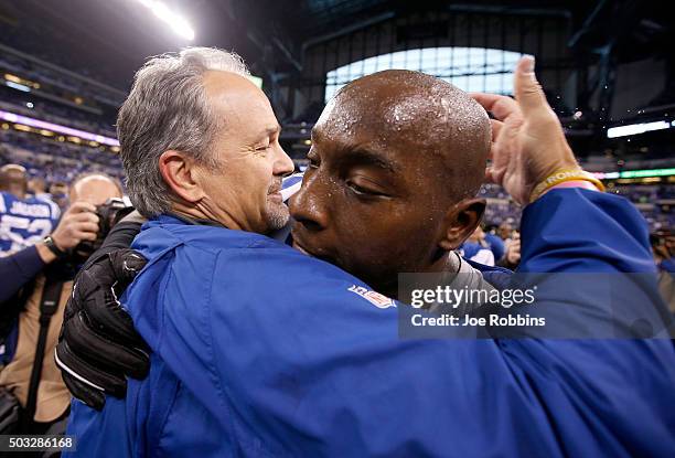 Head coach Chuck Pagano and Robert Mathis of the Indianapolis Colts embrace after the game against the Tennessee Titans at Lucas Oil Stadium on...