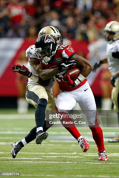 Justin Hardy of the Atlanta Falcons makes a catch against Kyle Wilson of the New Orleans Saints during the second half at the Georgia Dome on January...