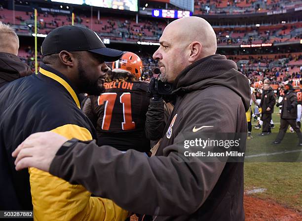 Head coach Mike Pettine of the Cleveland Browns congratulates head coach Mike Tomlin of the Pittsburgh Steelers after Pittsburgh's 28-12 win at...