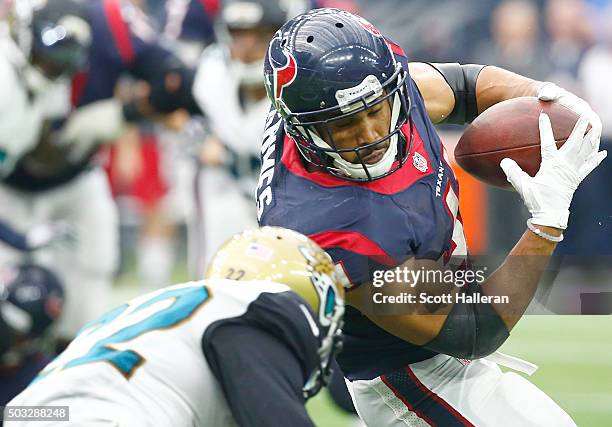 Jonathan Grimes of the Houston Texans rushes against Aaron Colvin of the Jacksonville Jaguars on January 3, 2016 at NRG Stadium in Houston, Texas.