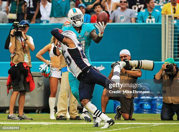 DeVante Parker of the Miami Dolphins catches a pass over Logan Ryan of the New England Patriots during the fourth quarter of the game at Sun Life...