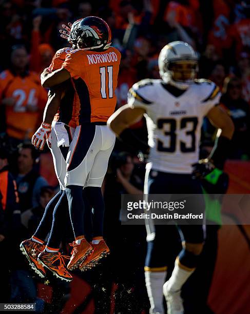 Wide receiver Demaryius Thomas of the Denver Broncos celebrates with wide receiver Jordan Norwood after scoring on a 72 yard touchdown reception in...