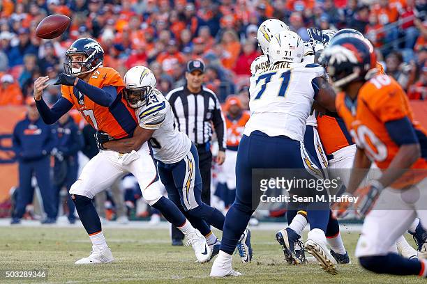Quarterback Brock Osweiler of the Denver Broncos fumbles as he is hit by cornerback Steve Williams of the San Diego Chargers in the second quarter of...