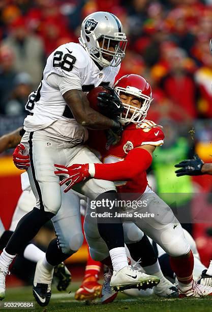 Running back Latavius Murray of the Oakland Raiders carries the ball as inside linebacker Josh Mauga of the Kansas City Chiefs defends during the...