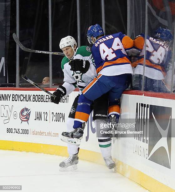 Travis Moen of the Dallas Stars steps into Calvin de Haan of the New York Islanders during the first period at the Barclays Center on January 3, 2016...
