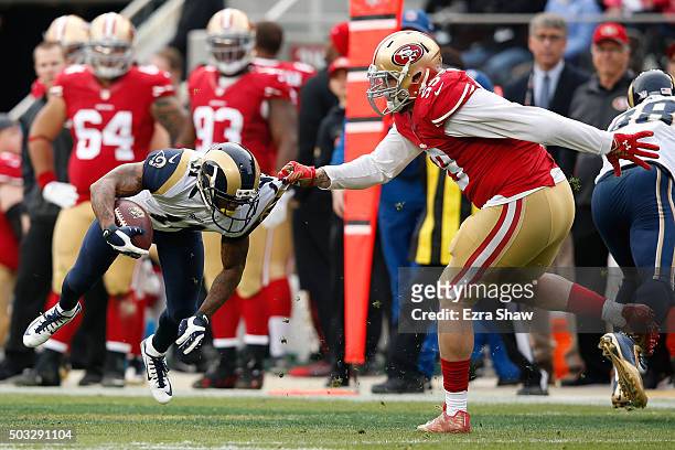 Aaron Lynch of the San Francisco 49ers spins Tavon Austin of the St. Louis Rams to the ground during their NFL game at Levi's Stadium on January 3,...