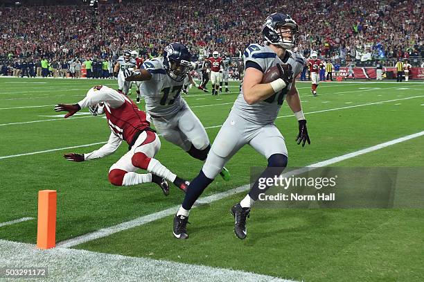 Tight end Chase Coffman of the Seattle Seahawks runs in an eight yard touchdown in the first half against the Arizona Cardinals at University of...