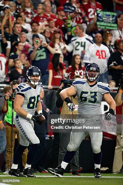 Tight end Chase Coffman of the Seattle Seahawks celebrates alongside offensive guard Mark Glowinski after Coffman scores an eight yard touchdown in...