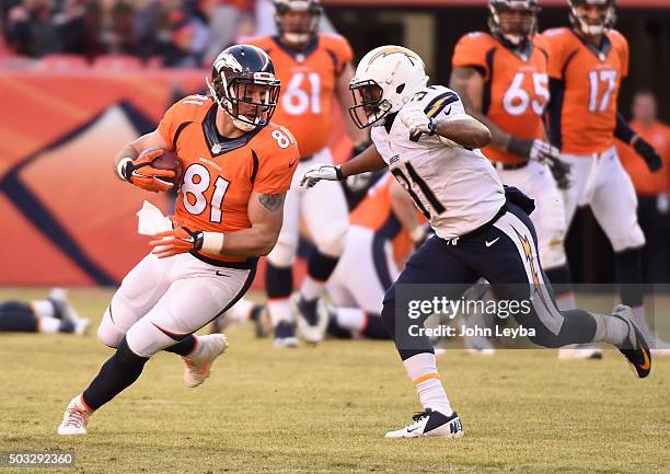 Denver Broncos tight end Owen Daniels pics up a few yards after his catch in front of San Diego Chargers cornerback Adrian Phillips during the second...