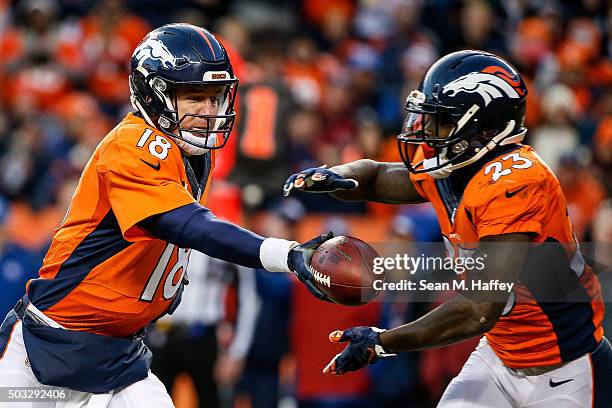 Quarterback Peyton Manning of the Denver Broncos, who entered the game after Brock Osweiler sustained an injury, hands off to running back Ronnie...