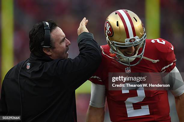 Head coach Jim Tomsula of the San Francisco 49ers speaks with Blaine Gabbert on the sidelines during their NFL game against the St. Louis Rams at...