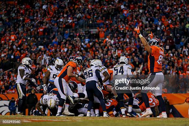 Tight end Owen Daniels of the Denver Broncos begins to celebrate as running back C.J. Anderson of the Denver Broncos scores a touchdown on a 1-yard...