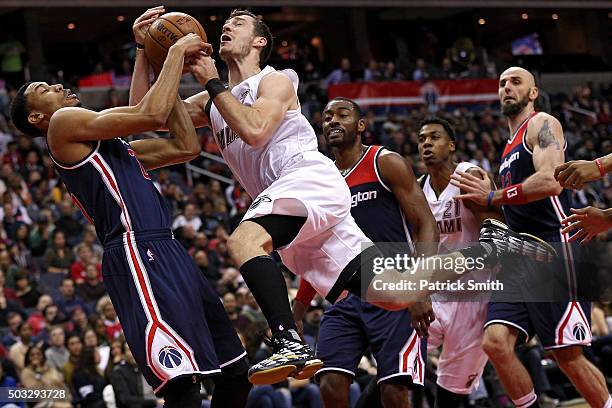 Goran Dragic of the Miami Heat has his shot blocked by Otto Porter Jr. #22 of the Washington Wizards during the first half at Verizon Center on...