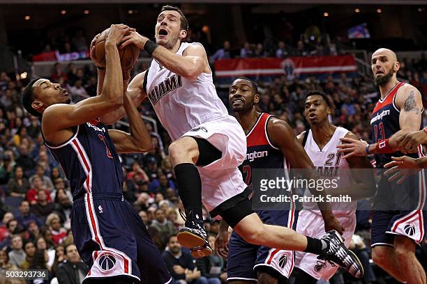 Goran Dragic of the Miami Heat has his shot blocked by Otto Porter Jr. #22 of the Washington Wizards during the first half at Verizon Center on...