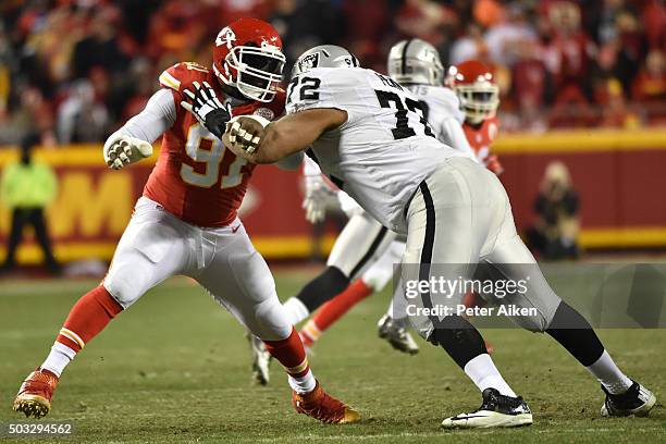 Tamba Hali of the Kansas City Chiefs rushes the passer while being blocked by Donald Penn of the Oakland Raiders at Arrowhead Stadium during the...