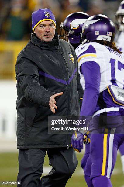 Head coach Mike Zimmer of the Minnesota Vikings greets Jarius Wright of the Minnesota Vikings prior to their game against the Green Bay Packers at...