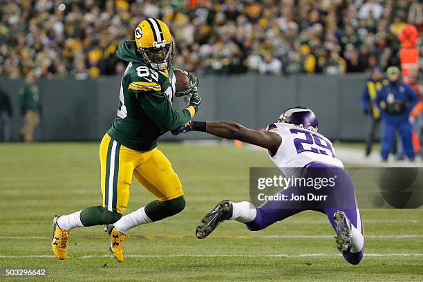 James Jones of the Green Bay Packers runs with the ball as Xavier Rhodes of the Minnesota Vikings attempts to tackle him during the first quarter of...