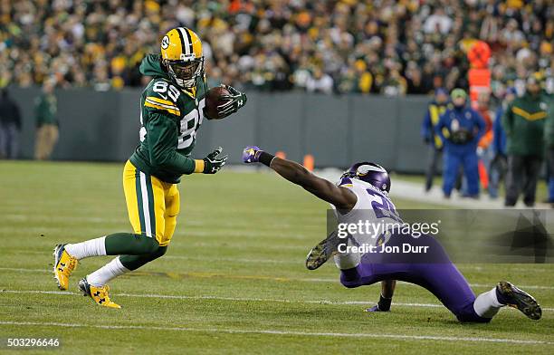 James Jones of the Green Bay Packers runs with the ball as Xavier Rhodes of the Minnesota Vikings attempts to tackle him during the first quarter of...