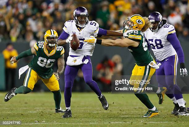 Teddy Bridgewater of the Minnesota Vikings stiff arms Clay Matthews of the Green Bay Packers during the second quarter of their game at Lambeau Field...