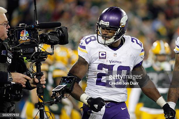 Adrian Peterson of the Minnesota Vikings celebrates scoring a touchdown during the third quarter against the Green Bay Packers at Lambeau Field on...