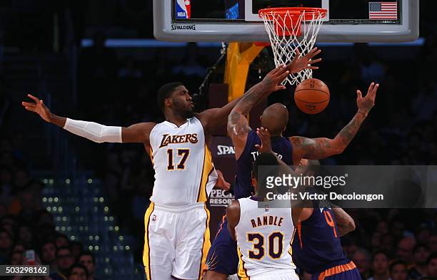 Roy Hibbert of the Los Angeles Lakers blocks a scoring attempt by P.J. Tucker of the Phoenix Suns in the first half during the NBA game at Staples...