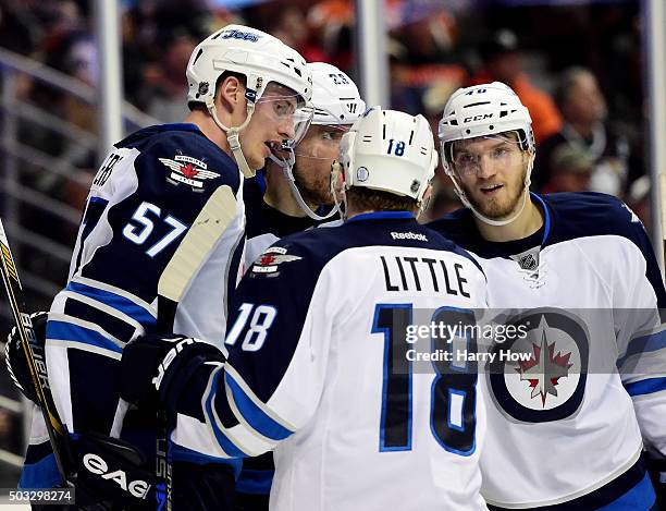 Tyler Myers of the Winnipeg Jets celebrates his goal with Blake Wheeler, Bryan Little and Joel Armia to trail 3-1 to the Anaheim Ducks during the...