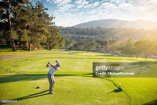 golfer on the tee box - golf swing sunset stock pictures, royalty-free photos & images