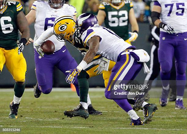 Micah Hyde of the Green Bay Packers intercepts a pass intended for Mike Wallace of the Minnesota Vikings during the third quarter of their game at...