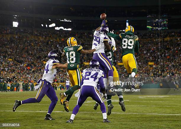 Aaron Rodgers of the Green Bay Packers is unable to complete a hail mary pass during the fourth quarter against the Minnesota Vikings at Lambeau...