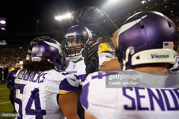 Anthony Barr of the Minnesota Vikings celebrates with Eric Kendricks and Andrew Sendejo after defeating the Green Bay Packers at Lambeau Field on...