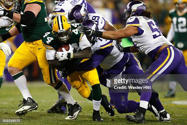 Sharrif Floyd of the Minnesota Vikings tackles James Starks of the Green Bay Packers during the second half at Lambeau Field on January 3, 2016 in...