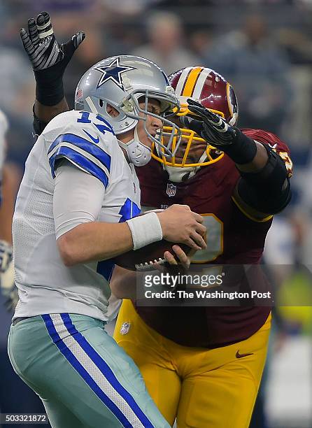 Dallas quarterback Kellen Moore left, is scaled in the 3rd quarter by Washington defensive end Chris Baker during the Washington Redskins defeat of...