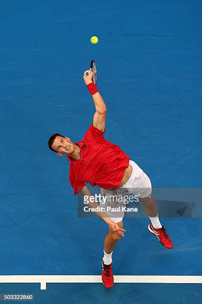 Kenny De Schepper of France serves in his singles match against Andy Murray of Great Britain during day two of the 2016 Hopman Cup at Perth Arena on...